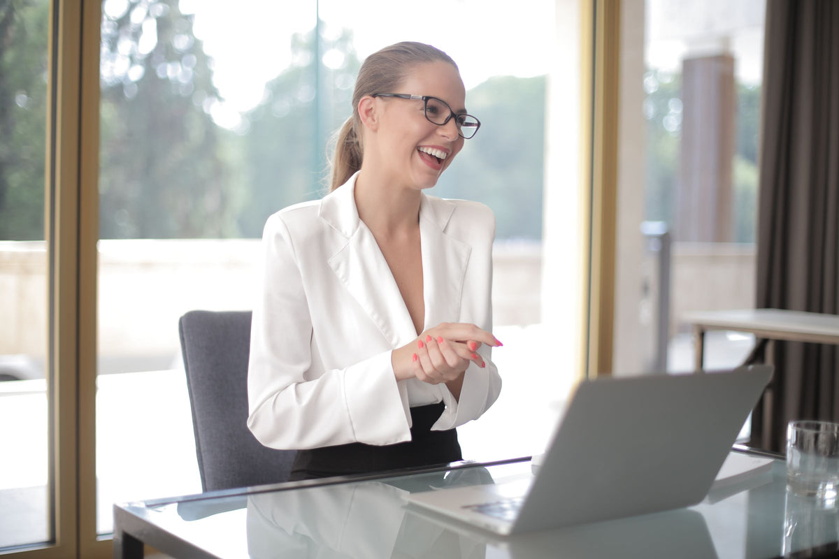 Professional working on a laptop at a bright modern desk